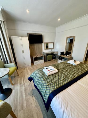 a hotel room with a bed and a desk at Hotel Coco in Felixstowe