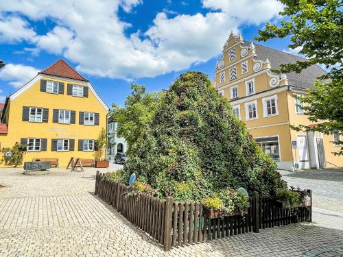 a large bush in front of a building at Holiday Home Tiny Haus Neschtle by Interhome in Wemding