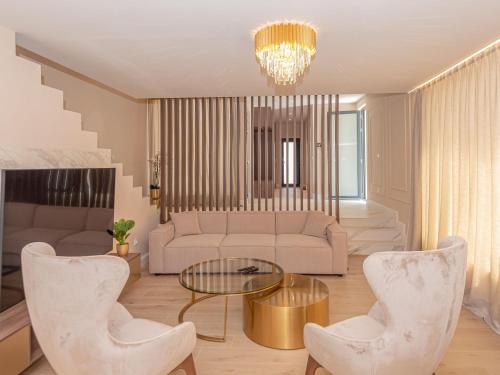 a living room with a couch and a table and chairs at Villa Šimun by Interhome in Zaton