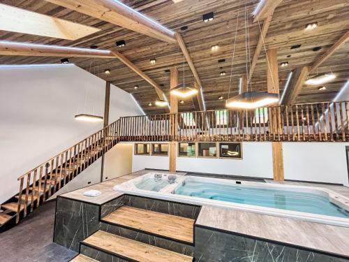 a hot tub in a room with wooden ceilings at Apartment Großer Kessel by Interhome in Kleinsölk