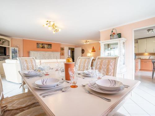 une salle à manger pourvue d'une table avec des assiettes et de l'argenterie dans l'établissement Apartment Les Cascades du Lac by Interhome, au Cannet