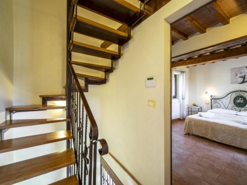 a staircase leading to a bedroom with a bed at Holiday Home La Dama by Interhome in Poggioni