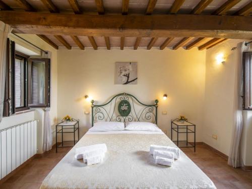a bedroom with a large bed with two tables at Holiday Home La Dama by Interhome in Poggioni