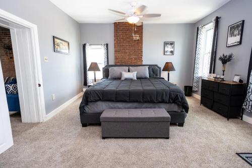 a bedroom with a bed and a ceiling fan at Cozy Haven at the footsteps of Harbor East in Baltimore