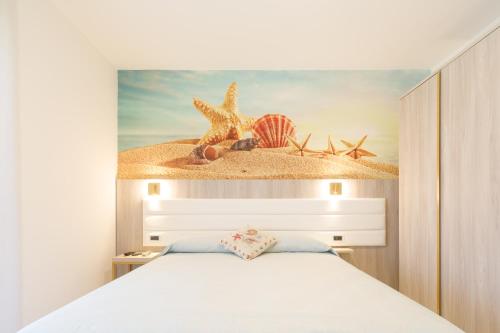 a bedroom with a bed and a painting of a beach at Villa Maredona in Ascea
