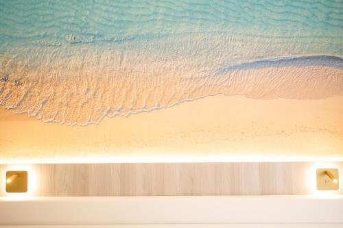a painting of a beach with the ocean at Villa Maredona in Ascea