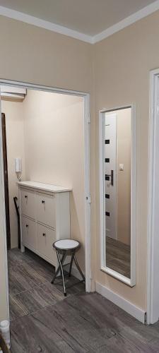 a room with a mirror and a table and a chair at Apartmán pri hrade in Levice