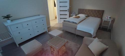 a small bedroom with a bed and a dresser at Apartmán pri hrade in Levice