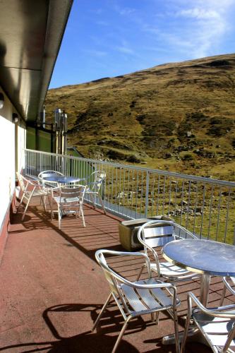 a group of tables and chairs on a deck at Hotel Cims Pas de La Casa in Pas de la Casa