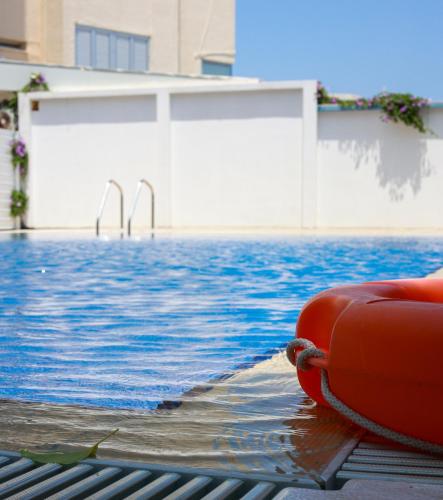a redotation device sitting next to a swimming pool at Piale Palms Makenzie Beach Front Apartment Larnaca Airport Area in Larnaca