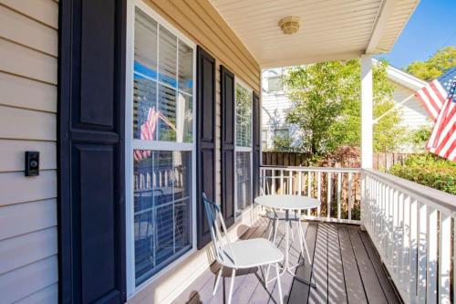 a porch with a table and chairs on it at Hazel's Happy Hideaway- Midtown Mobile! in Mobile