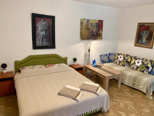 a living room with two beds and a couch at Axenia Hotel in Utjeha