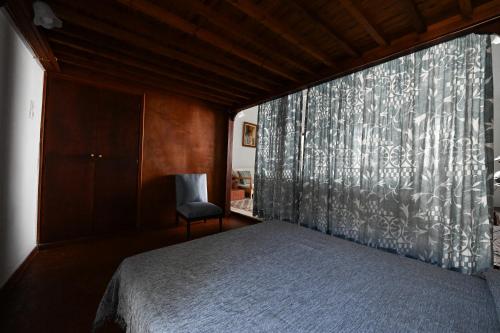 a bedroom with a bed and a window at Traditional & Cosy Apartment Batsi in Batsi