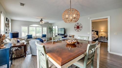 a dining room and living room with a table and chairs at 55C Anchors Away II at True Blue condo by Peace Vacations in Pawleys Island