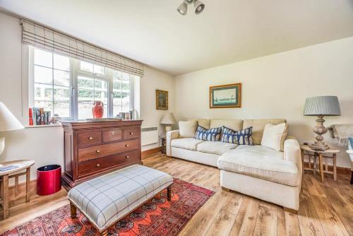 a living room with a couch and a table at Charming Annexe Lodge with Parking Pass The Keys in Midhurst