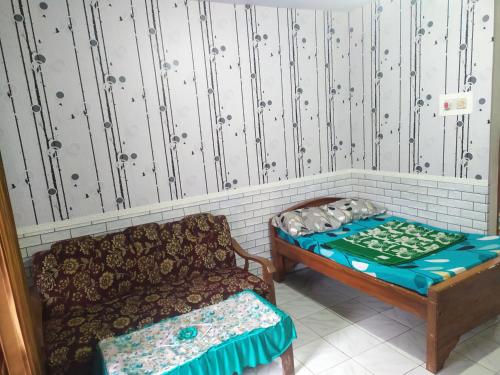 a small room with a couch and a bed at Lusman Homestay Bromo in Ngadisari