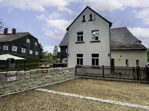 a white house with a fence in front of it at Apartment Frushi by Interhome in Großschönau