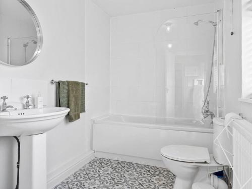 a white bathroom with a sink and a tub and a toilet at Pass the Keys Newly Renovated 2 Bed Property. in Cleator Moor