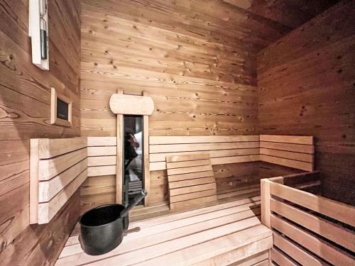 a wooden sauna with a bucket in the middle at Apartment Hideaway Planneralm by Jufa Hotels-3 by Interhome in Donnersbach