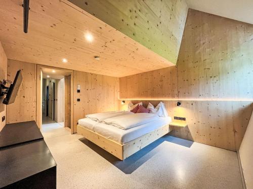 a bedroom with a large bed in a room at Apartment Hideaway Planneralm by Jufa Hotels-3 by Interhome in Donnersbach