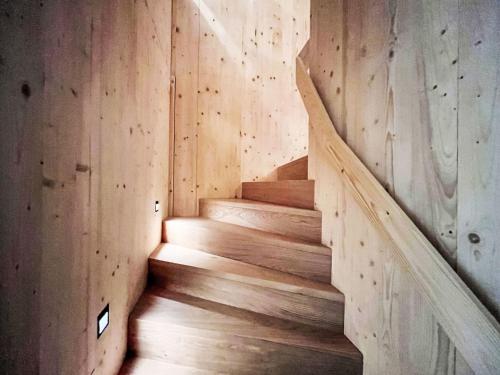 a staircase in a room with wooden walls and wooden floors at Apartment Hideaway Planneralm by Jufa Hotels-3 by Interhome in Donnersbach