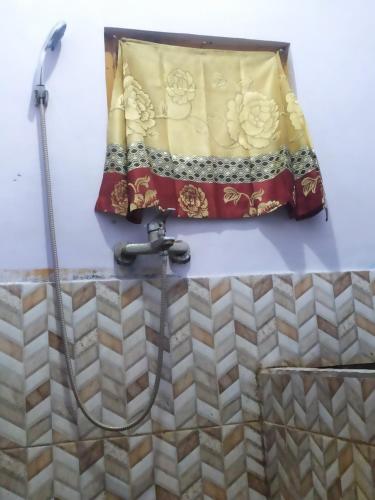 a bathroom with a shower and a sink at Lusman Homestay Bromo in Ngadisari