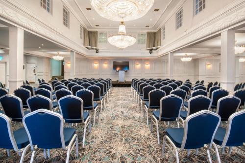a conference room with chairs and a podium in the middle at London Chigwell Prince Regent Hotel, BW Signature Collection in London
