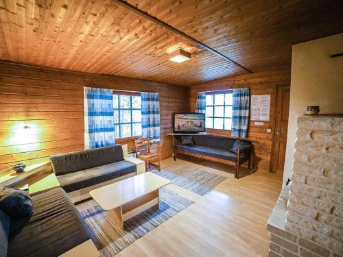 a living room with a couch and a table at Holiday Home Heikkilä by Interhome in Kuusamo