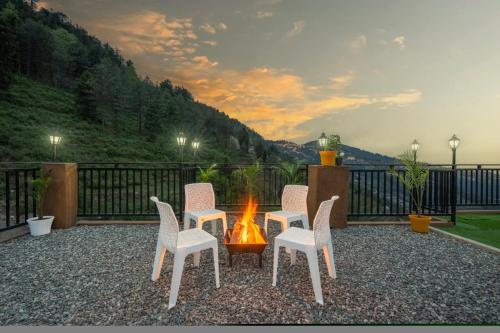 a group of chairs sitting around a fire pit at The Green Trails Kufri I Vacations I Conference I MICE I Family Events I Open Air Terrace I Sky Bonfire I Wooden Rooms With Pvt Balconies I by Exotic Stays in Kūfrī