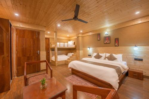 a bedroom with a bed and a bunk bed at The Green Trails Kufri I Vacations I Conference I MICE I Family Events I Open Air Terrace I Sky Bonfire I Wooden Rooms With Pvt Balconies I by Exotic Stays in Kūfrī