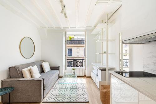 un salon avec un canapé et une table dans l'établissement GuestReady - Charmant studio lumineux à Paris, à Paris