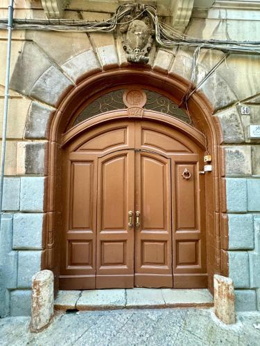 a large wooden door on the side of a building at Onny's House in Bari