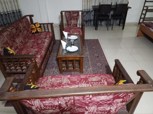 a living room with a couch and a table at Hotel Friendstar in Minuwangoda