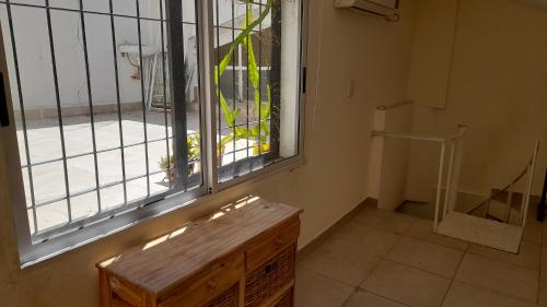 an empty room with a window and a wooden bench at La Casita in Buenos Aires