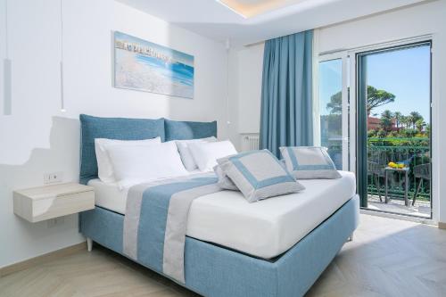 a bedroom with a bed and a large window at Sea View Deluxe Apartments in Vico Equense