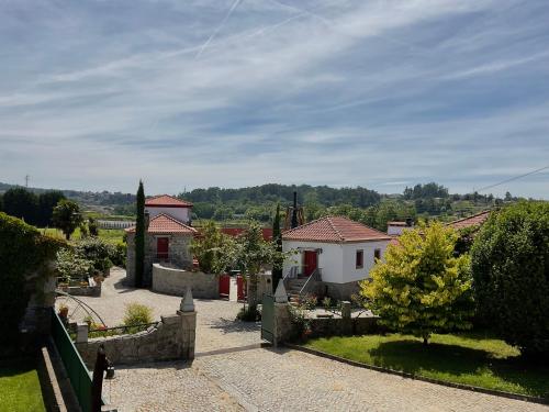 a view of a yard with houses and trees at Quinta de Maderne in Felgueiras