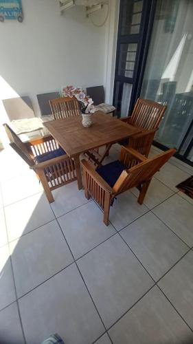 a wooden table and chairs sitting on a balcony at 521 at The Blyde in Pretoria
