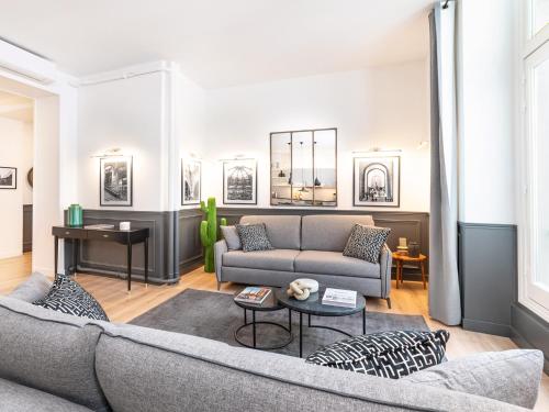 un salon avec un canapé et une table dans l'établissement LivinParis - Luxury AC 3 Bedrooms Le Louvre I, à Paris