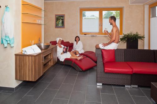 a group of people sitting in a waiting room at Villa Sonnwend National Park Lodge in Rossleithen