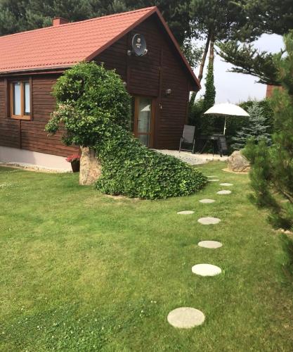 a yard with stepping stones in the grass at Agroturystyka Krajno - Zagórze in Krajno-Zagórze