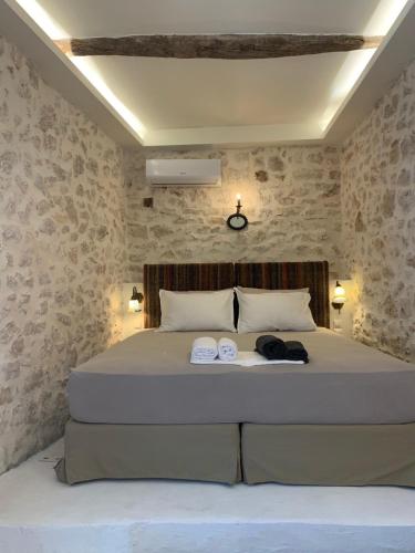 a bedroom with a bed with two towels on it at Amor Fati in Amfilochía