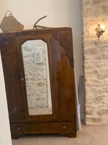 a wooden dresser with a mirror in a room at Amor Fati in Amfilochía