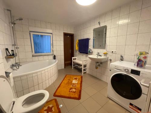 a bathroom with a tub and a toilet and a sink at DUO am Residenzschloss Ludwigsburg in Ludwigsburg