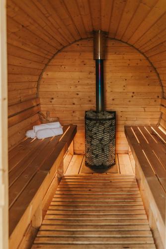 an inside of a sauna with two benches and a heater at Agroturystyka nad jeziorem-Herrmann hof in Dejguny