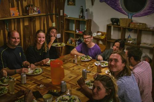 a group of people sitting around a table at Casa Satoshi in San Cristóbal de Las Casas