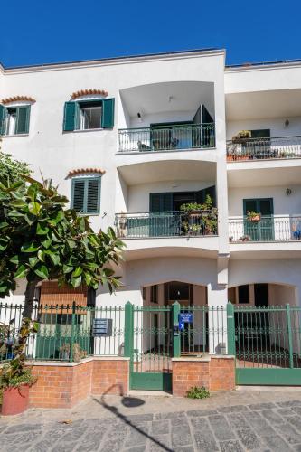 an apartment building with balconies and a fence at Sea View Deluxe Apartments in Vico Equense