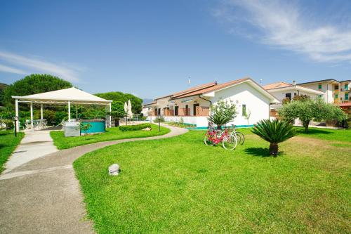 a path in a yard with a house and a tent at Villa Maredona in Ascea