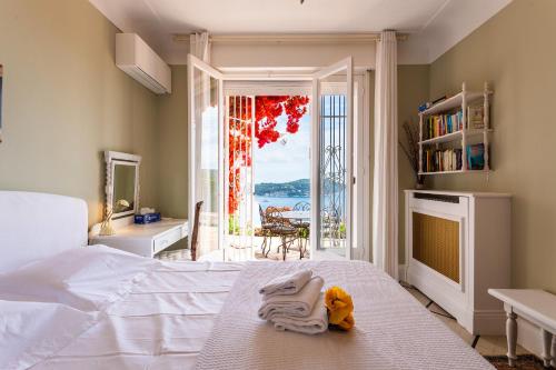 a bedroom with a bed and a view of the ocean at ROMANTIC VILLA VI4412 By Riviera Holiday Homes in Villefranche-sur-Mer