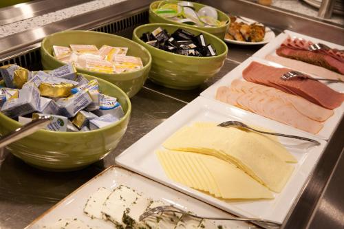 a buffet with different types of meats and cheese at Holiday Inn Berlin City East Side by IHG in Berlin