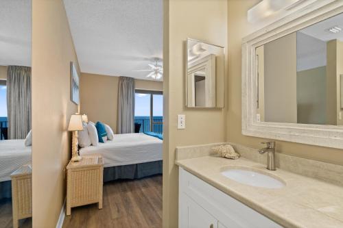 a bathroom with a sink and a bedroom with a bed at Phoenix 6 Unit 1213 in Orange Beach